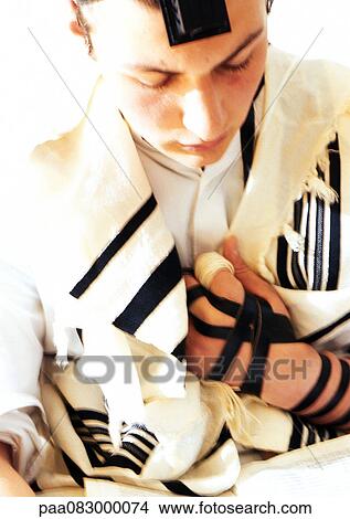 Jewish man wearing Tefillin and Tallith for prayer, close-up View Large Photo Image Picture - Jewish man wearing Tefillin and Tallith for prayer, close-up. Fotosearch