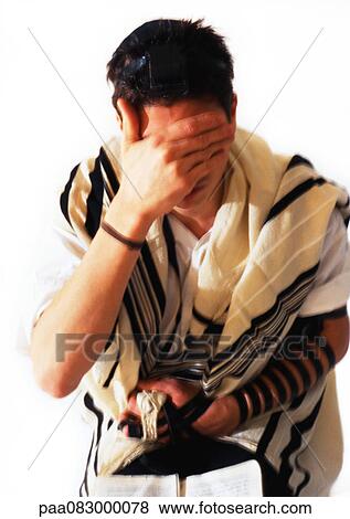 Jewish man wearing Tefillin and Tallith for prayer, covering face with hand, close-up View Large Photo Image Stock Photo - Jewish man wearing Tefillin and Tallith for prayer, covering face with hand, close-up. Fotosearch