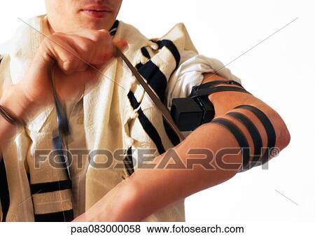 Jewish man wrapping arm with straps of Teffilin View Large Photo Image Stock Photo - Jewish man wrapping arm with straps of Teffilin. Fotosearch