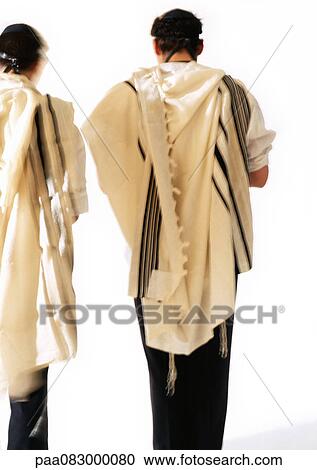 Stock Image - Jewish men wearing Tefillin and Tallith for prayer, rear view. Fotosearch