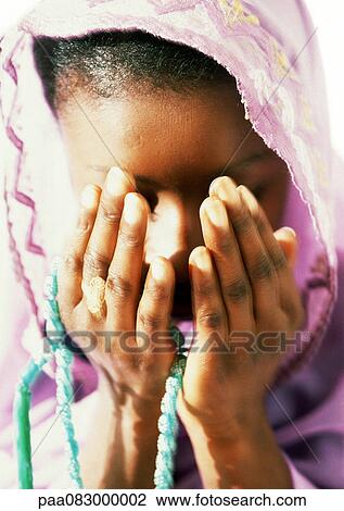 Muslim woman praying with prayer beads, close-up View Large Photo Image Stock Image - Muslim woman praying with prayer beads, close-up. Fotosearch