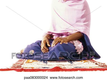 Muslim woman sitting on prayer rug View Large Photo Image Picture - Muslim woman sitting on prayer rug. Fotosearch