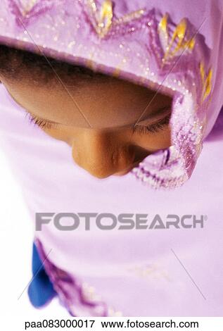 Stock Photo - Muslim woman wearing veil, close-up, high angle view. Fotosearch