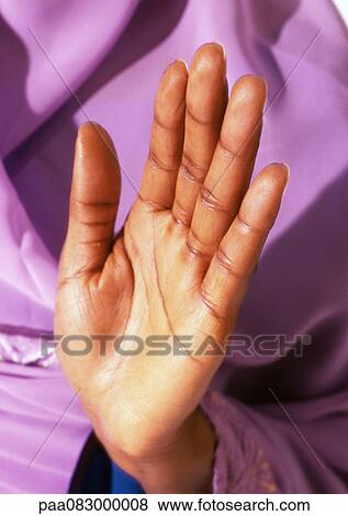 Stock Photo - Woman's palm held up in prayer, close-up. Fotosearch