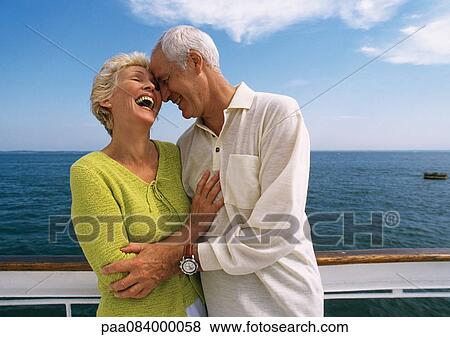 Mature couple embracing, laughing on boat deck. View Large Photo Image Stock Photo - Mature couple embracing, laughing on boat deck. . Fotosearch