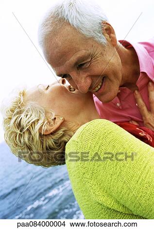 Mature couple embracing, laughing, close-up View Large Photo Image Picture - Mature couple embracing, laughing, close-up. Fotosearch