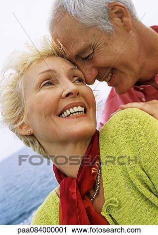 Stock Image - Mature couple forehead to forehead, close-up. Fotosearch