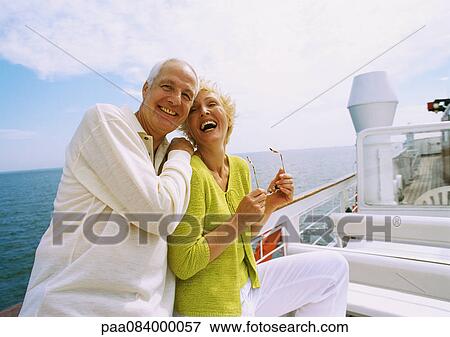 Mature couple posing on boat deck, laughing View Large Photo Image Stock Photo - Mature couple posing on boat deck, laughing. Fotosearch