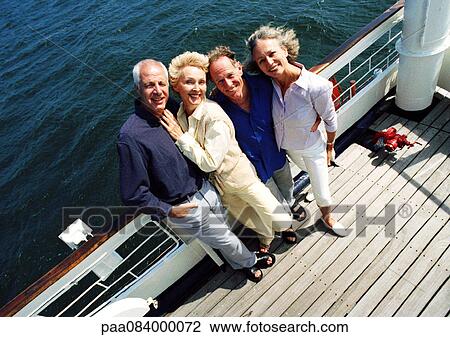Mature couples standing next to railing of boat, portrait, high angle view View Large Photo Image Stock Image - Mature couples standing next to railing of boat, portrait, high angle view. Fotosearch