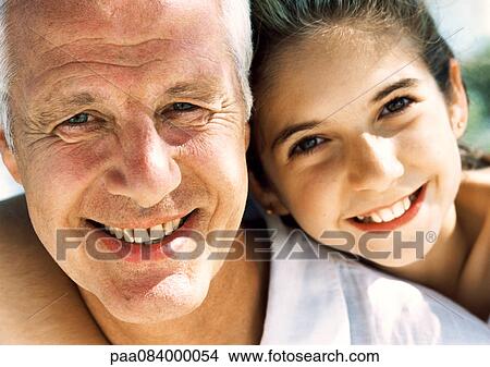 Mature man and girl smiling, close up, portrait. View Large Photo Image Picture - Mature man and girl smiling, close up, portrait.. Fotosearch