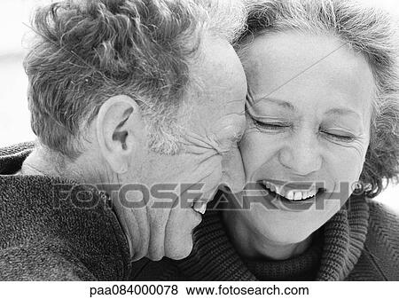 Stock Photo - Mature man and woman smiling, close up, portrait, B&W.. Fotosearch
