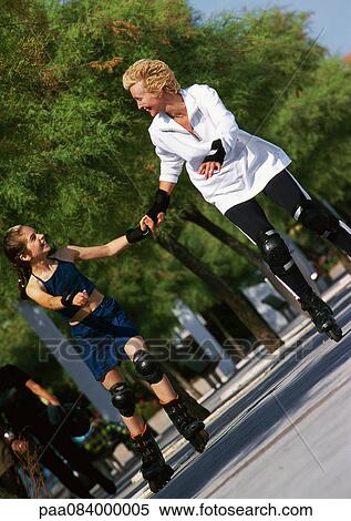 Mature woman and girl holding hands, in-line skating. View Large Photo Image Stock Photography - Mature woman and girl holding hands, in-line skating.. Fotosearch