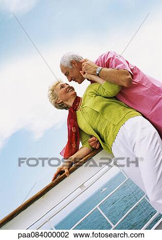 Mature woman looking at senior man, leaning on rail of boat. View Large Photo Image Stock Image - Mature woman looking at senior man, leaning on rail of boat.. Fotosearch