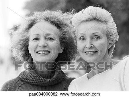 Two mature women smiling at camera, portrait, B&W. View Large Photo Image Stock Image - Two mature women smiling at camera, portrait, B&W.. Fotosearch