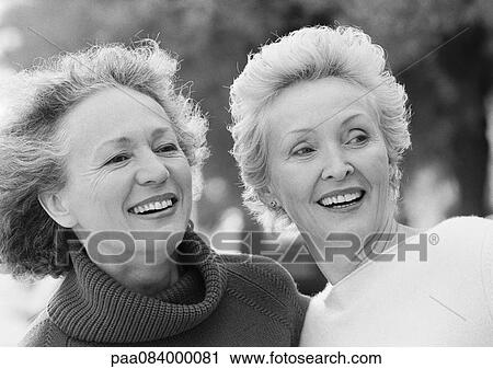 Stock Image - Two mature women smiling, portrait, B&W.. Fotosearch