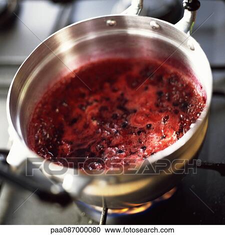 Stock Image - Close-up of berries being cooking in a pot on the stove.. Fotosearch