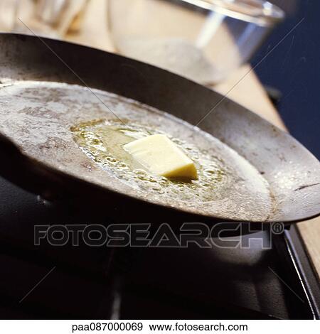 Stock Photo - Close-up of butter melting in pan.. Fotosearch