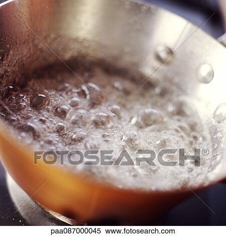 Stock Photography - Close-up of caramel bubbling in pan. Fotosearch