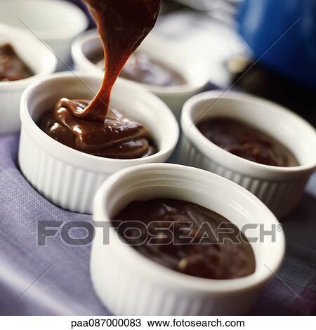 Stock Image - Close-up of chocolate mousse in ramekins. Fotosearch