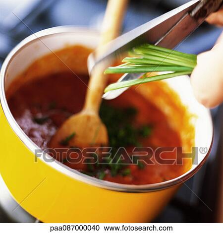 Close-up of cutting and mixing herbs into a sauce. View Large Photo Image Stock Image - Close-up of cutting and mixing herbs into a sauce.. Fotosearch