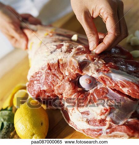 Close-up of hands preparing leg of lamb View Large Photo Image Stock Photography - Close-up of hands preparing leg of lamb. Fotosearch