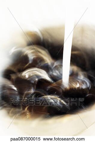 Stock Photography - Close-up of mussels being washed, blurry.. Fotosearch