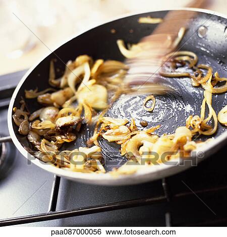 Close-up of onions being sauted in a pan. View Large Photo Image Stock Photograph - Close-up of onions being sauted in a pan.. Fotosearch