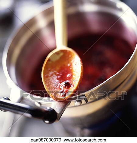 Close-up of spoon with berry juice over pot View Large Photo Image Stock Photo - Close-up of spoon with berry juice over pot. Fotosearch