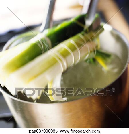 Close-up of tied leeks being taken out of pot, blurry. View Large Photo Image Stock Photography - Close-up of tied leeks being taken out of pot, blurry.. Fotosearch