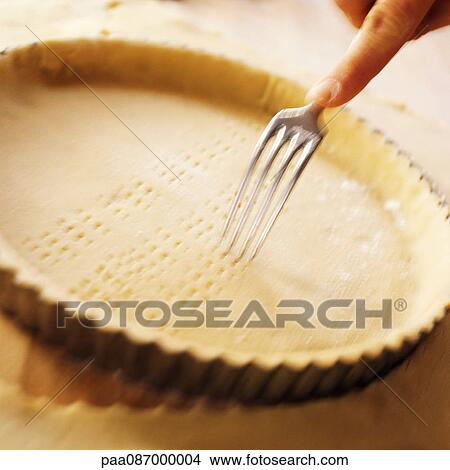 Picture - Making marks in pie crust with fork, blurry.. Fotosearch