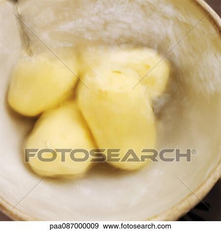Peeled potatoes in bowl, blurry. View Large Photo Image Stock Photo - Peeled potatoes in bowl, blurry.. Fotosearch