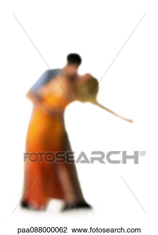 Stock Image - Silhouette of couple dancing, on white background, defocused. Fotosearch