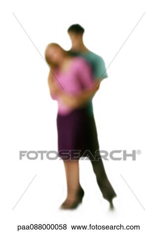 Stock Photo - Silhouette of man embracing woman from behind, on white background, defocused. Fotosearch