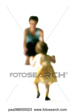 Stock Image - Silhouette of mother bending down, holding out arms to toddler, on white background, defocused. Fotosearch
