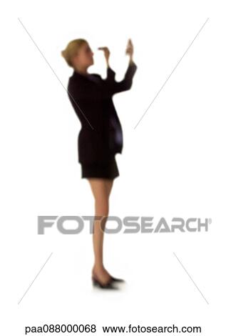 Stock Photo - Silhouette of woman putting on make-up, on white background, defocused. Fotosearch