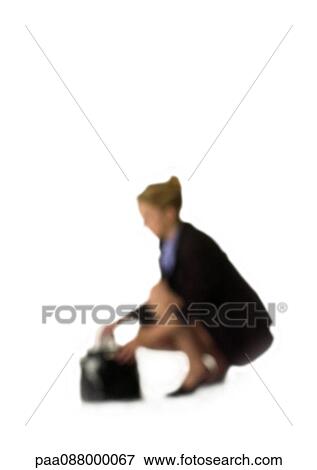Stock Photo - Silhouette of woman sqatting down next to purse, on white background, defocused. Fotosearch