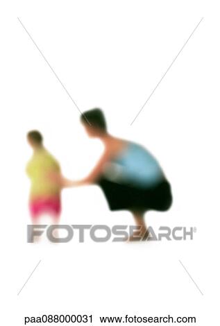 Stock Image - Silhouette of woman squatting down next to child, on white background, defocused. Fotosearch
