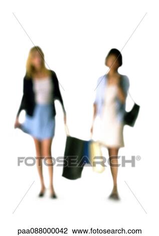 Stock Image - Silhouette of women carrying shopping bags, on white background, defocused. Fotosearch