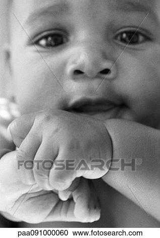 Stock Image - Baby looking at camera, close-up, b&w. Fotosearch