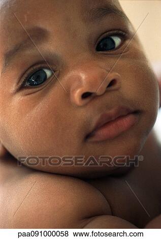 Stock Photo - Baby looking at camera, close-up. Fotosearch