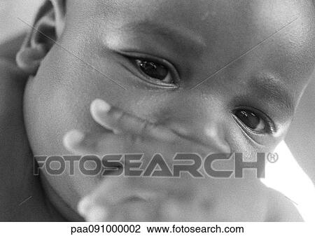 Baby with hand in front of mouth, close-up, b&w View Large Photo Image Stock Image - Baby with hand in front of mouth, close-up, b&w. Fotosearch