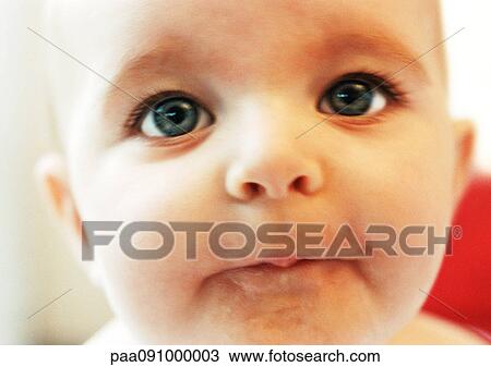 Stock Image - Baby's face, close-up. Fotosearch
