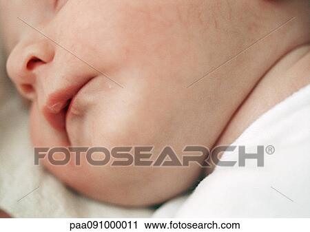 Stock Image - Baby's face, close-up. Fotosearch