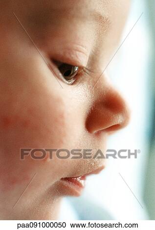 Stock Image - Baby's face, side view, close-up. Fotosearch
