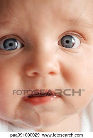 Baby's face with drool on chin, looking at camera, close-up View Large Photo Image Stock Photo - Baby's face with drool on chin, looking at camera, close-up. Fotosearch