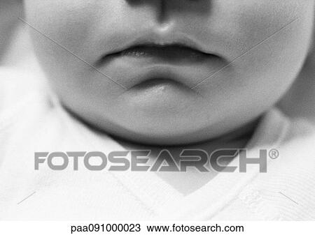 Stock Image - Baby's mouth, close-up, b&w. Fotosearch
