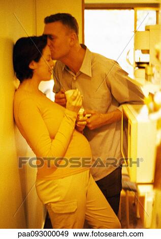 Man kissing pregnant woman's forehead, yellow tone View Large Photo Image Stock Photo - Man kissing pregnant woman's forehead, yellow tone. Fotosearch