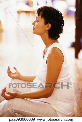 Pregnant woman sitting in meditation position, side view View Large Photo Image Stock Photo - Pregnant woman sitting in meditation position, side view. Fotosearch