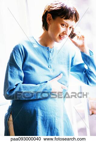 Pregnant woman using cell phone, portrait View Large Photo Image Stock Image - Pregnant woman using cell phone, portrait. Fotosearch