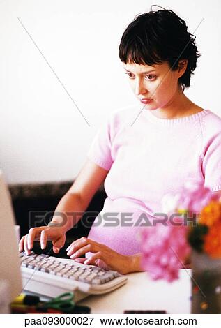 Pregnant woman working on computer View Large Photo Image Stock Photo - Pregnant woman working on computer. Fotosearch